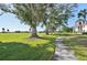 Landscaped walkway meandering through lush green space at 760 Village Cir # 109, Venice, FL 34292
