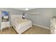 Cozy bedroom with queen-size bed and built-in shelving at 8365 Shadow Pine Way, Sarasota, FL 34238