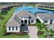 Luxury home with lake view, paver driveway, and landscaped yard at 8367 Sea Glass Ct, Sarasota, FL 34240
