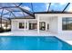 Backyard showcasing a pristine pool, covered patio, and modern architectural design, perfect for outdoor entertaining at 8367 Sea Glass Ct, Sarasota, FL 34240