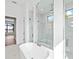 Bright bathroom features a soaking tub, walk-in shower, and marble floors at 8367 Sea Glass Ct, Sarasota, FL 34240