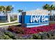 Welcoming community entrance sign for Wild Blue at Waterside, surrounded by colorful flowers and manicured landscaping at 8367 Sea Glass Ct, Sarasota, FL 34240