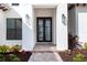 Elegant entryway with a modern black double door and brick walkway at 8367 Sea Glass Ct, Sarasota, FL 34240