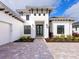White modern home with dark entry door at 8367 Sea Glass Ct, Sarasota, FL 34240