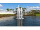 Picturesque pond features a graceful fountain, lush landscaping, and tranquil setting for community enjoyment at 8367 Sea Glass Ct, Sarasota, FL 34240