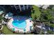 Inviting kidney-shaped pool with lounge chairs and umbrellas, seen from above at 8779 Midnight Pass Rd # 504H, Sarasota, FL 34242