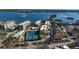 Aerial view showing condo building, pool, tennis courts, and waterfront location at 8779 Midnight Pass Rd # 504H, Sarasota, FL 34242