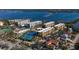 Aerial view of waterfront condo community with tennis courts and marina at 8779 Midnight Pass Rd # 504H, Sarasota, FL 34242