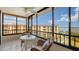 Screened balcony with wicker furniture and a view of the water at 8779 Midnight Pass Rd # 504H, Sarasota, FL 34242