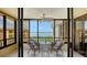 Spacious screened balcony with water view and ceiling fan at 8779 Midnight Pass Rd # 504H, Sarasota, FL 34242