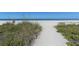 Scenic beach access with sandy path and ocean views at 8779 Midnight Pass Rd # 504H, Sarasota, FL 34242