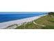 Aerial view of a pristine beach with calm water at 8779 Midnight Pass Rd # 504H, Sarasota, FL 34242
