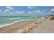 Scenic view of a wide sandy beach and clear ocean water at 8779 Midnight Pass Rd # 504H, Sarasota, FL 34242