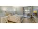 Main bedroom with light flooring and access to balcony at 8779 Midnight Pass Rd # 504H, Sarasota, FL 34242