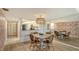 Bright dining room featuring a round table and wicker chairs at 8779 Midnight Pass Rd # 504H, Sarasota, FL 34242