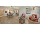 Open concept dining area with wicker chairs and hardwood floors at 8779 Midnight Pass Rd # 504H, Sarasota, FL 34242