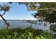 Serene view of a dock extending into calm waters at 8779 Midnight Pass Rd # 504H, Sarasota, FL 34242