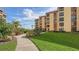 Well-maintained walkway through lush landscaping toward building entrance at 8779 Midnight Pass Rd # 504H, Sarasota, FL 34242