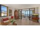 Living room with balcony access, hardwood floors, and water views at 8779 Midnight Pass Rd # 504H, Sarasota, FL 34242