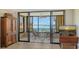 Living room with access to a screened balcony and water views at 8779 Midnight Pass Rd # 504H, Sarasota, FL 34242