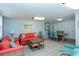 Bright living room with coral sofa and dining area at 8779 Midnight Pass Rd # 504H, Sarasota, FL 34242