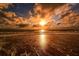 Stunning sunset over the ocean with waves on the shore at 8779 Midnight Pass Rd # 504H, Sarasota, FL 34242