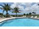 Relax by the refreshing pool with ocean views and lush landscaping at 8779 Midnight Pass Rd # 504H, Sarasota, FL 34242