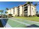 Outdoor shuffleboard court with green surface and building view at 8779 Midnight Pass Rd # 504H, Sarasota, FL 34242