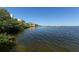 Scenic waterfront view with lush vegetation and calm waters at 8779 Midnight Pass Rd # 504H, Sarasota, FL 34242