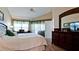 Main bedroom with king bed, private access, and large dresser at 11013 Jasmine Cir, Bradenton, FL 34209