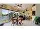 Casual dining area with glass table and wicker chairs overlooking the lake at 11013 Jasmine Cir, Bradenton, FL 34209