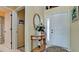Bright entryway with a half-moon table, mirror, and flower arrangement at 11013 Jasmine Cir, Bradenton, FL 34209