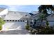 Well-maintained house with a white garage door and landscaped front yard at 11013 Jasmine Cir, Bradenton, FL 34209