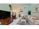 Open floor plan living room with a sectional sofa and large TV at 11013 Jasmine Cir, Bradenton, FL 34209