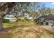 Large backyard with mature trees and privacy fence at 1868 Riviera Cir, Sarasota, FL 34232