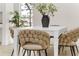 Close-up view of a white dining table with unique beige chairs at 1868 Riviera Cir, Sarasota, FL 34232