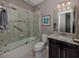 Bathroom with shower/tub combo, vanity, and framed art at 19696 Petrino St, Venice, FL 34293