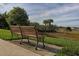 Park bench overlooking tranquil waterfront view with lush greenery at 19696 Petrino St, Venice, FL 34293