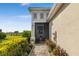 Exterior view of home showcasing a screened patio, landscaped walkway, and lush landscaping at 226 Van Gogh Cv, Bradenton, FL 34212