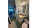 Guest bathroom with granite vanity and stackable washer/dryer at 2310 Gulf N Dr # 205, Bradenton Beach, FL 34217