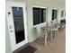 Beachfront condo entrance with private patio seating at 2310 Gulf N Dr # 205, Bradenton Beach, FL 34217