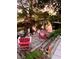Serene waterfront backyard with a dock and Adirondack chairs at 2426 Nassau St, Sarasota, FL 34231