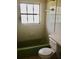 Clean bathroom with a vintage green bathtub and shower at 2426 Nassau St, Sarasota, FL 34231