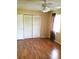 Spacious bedroom with wood-look flooring and large closet at 2426 Nassau St, Sarasota, FL 34231