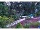Mature landscaping, stone pathway, and colorful flowers create a serene backyard oasis at 2426 Nassau St, Sarasota, FL 34231