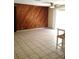 Living room with wood paneled accent wall and tile flooring at 2426 Nassau St, Sarasota, FL 34231