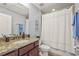 Clean bathroom with granite countertop, shower, and bathtub at 3033 Esmeralda Dr, Sarasota, FL 34243