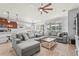 Open concept living room with kitchen views, featuring a sectional sofa and a rustic coffee table at 3033 Esmeralda Dr, Sarasota, FL 34243