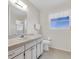 Clean bathroom with a vanity, toilet, and shower at 430 Botticelli Dr # 430, Nokomis, FL 34275