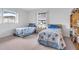 Two twin beds with blue bedding in a sunny bedroom at 430 Botticelli Dr # 430, Nokomis, FL 34275
